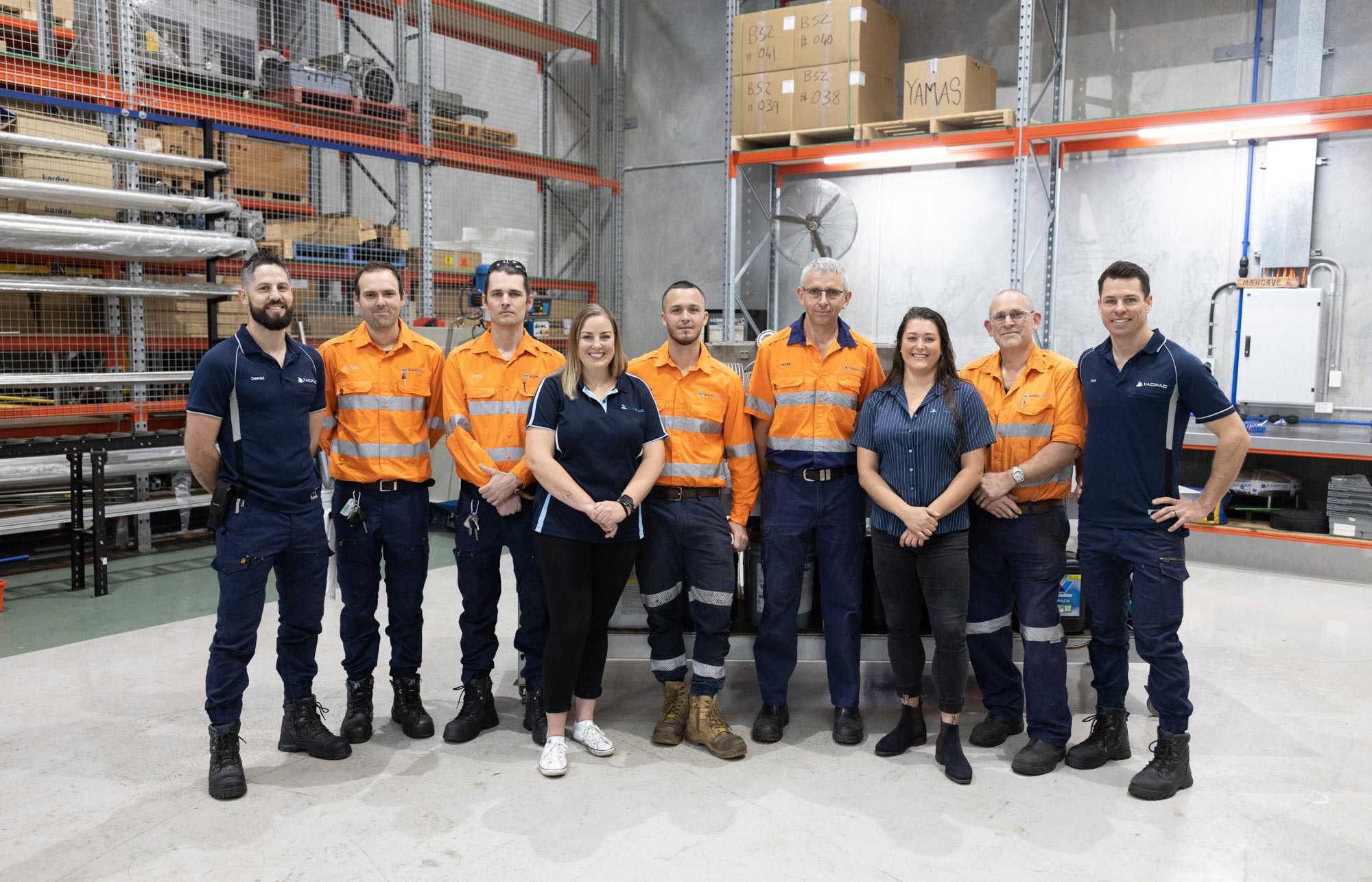 The team at VACPAC Australia posing for a picture in their warehouse.