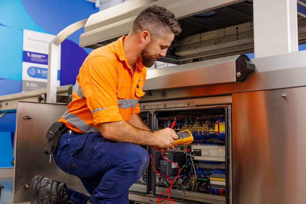 A VACPAC technician testing a vacuum packaging machine.