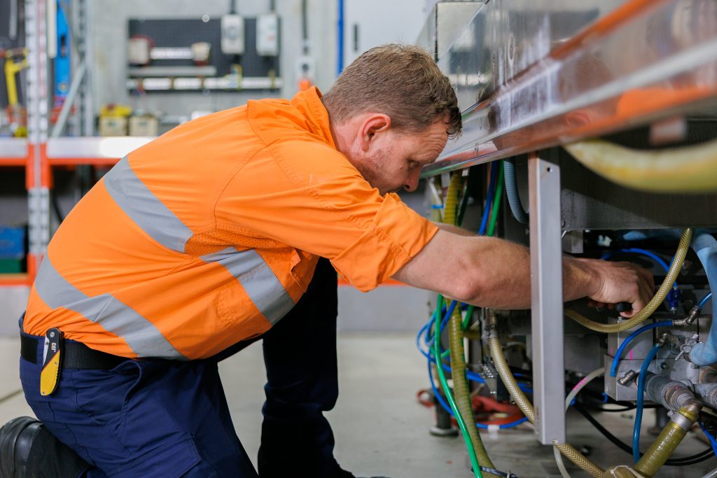 A VACPAC technician fixing a vacuum packaging machine.