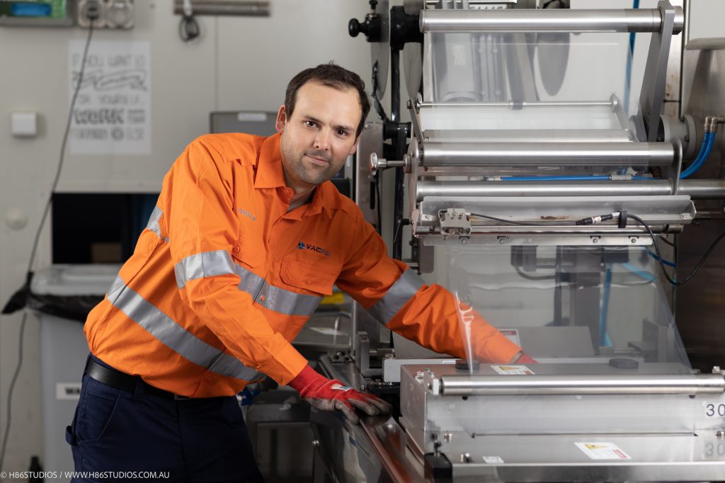 A VACPAC technician working on a vacuum packaging machine to optimise workflow.